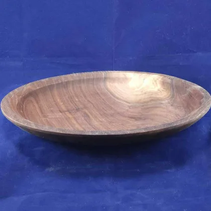 Hand-rubbed walnut platter on dark navy velvet backdrop.